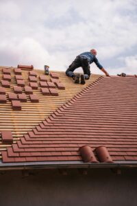 Roof replacement project timeline in Brooklyn NY showing workers installing new roofing system