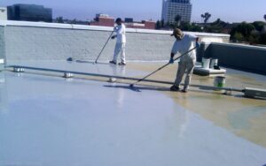 Flat roof maintenance in Brooklyn showing cleaning and inspection of drainage system on residential building